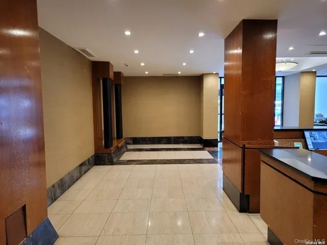 a view of a kitchen with a sink and a mirror