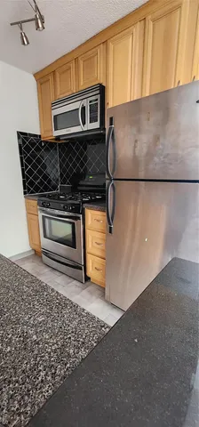 a kitchen with a stove and a microwave