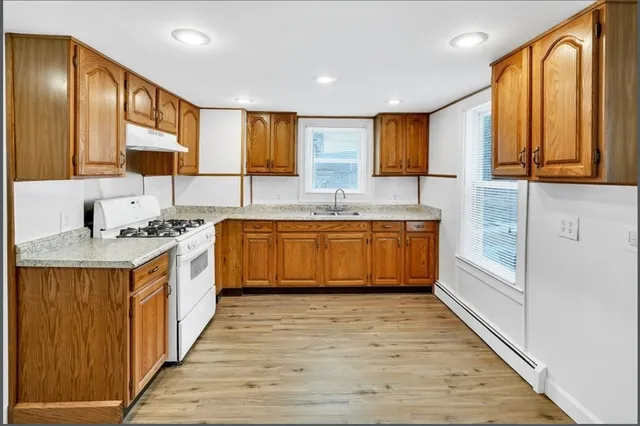 a bathroom with a double vanity sink a mirror and a bathtub
