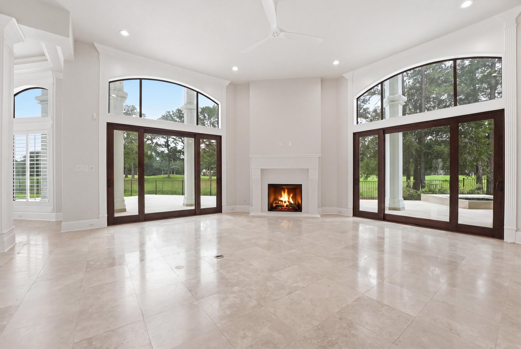 70 Quail Rock Place The Woodlands, TX 77381 - Photo 6 of 46 a view of an empty room with a fireplace and a window
