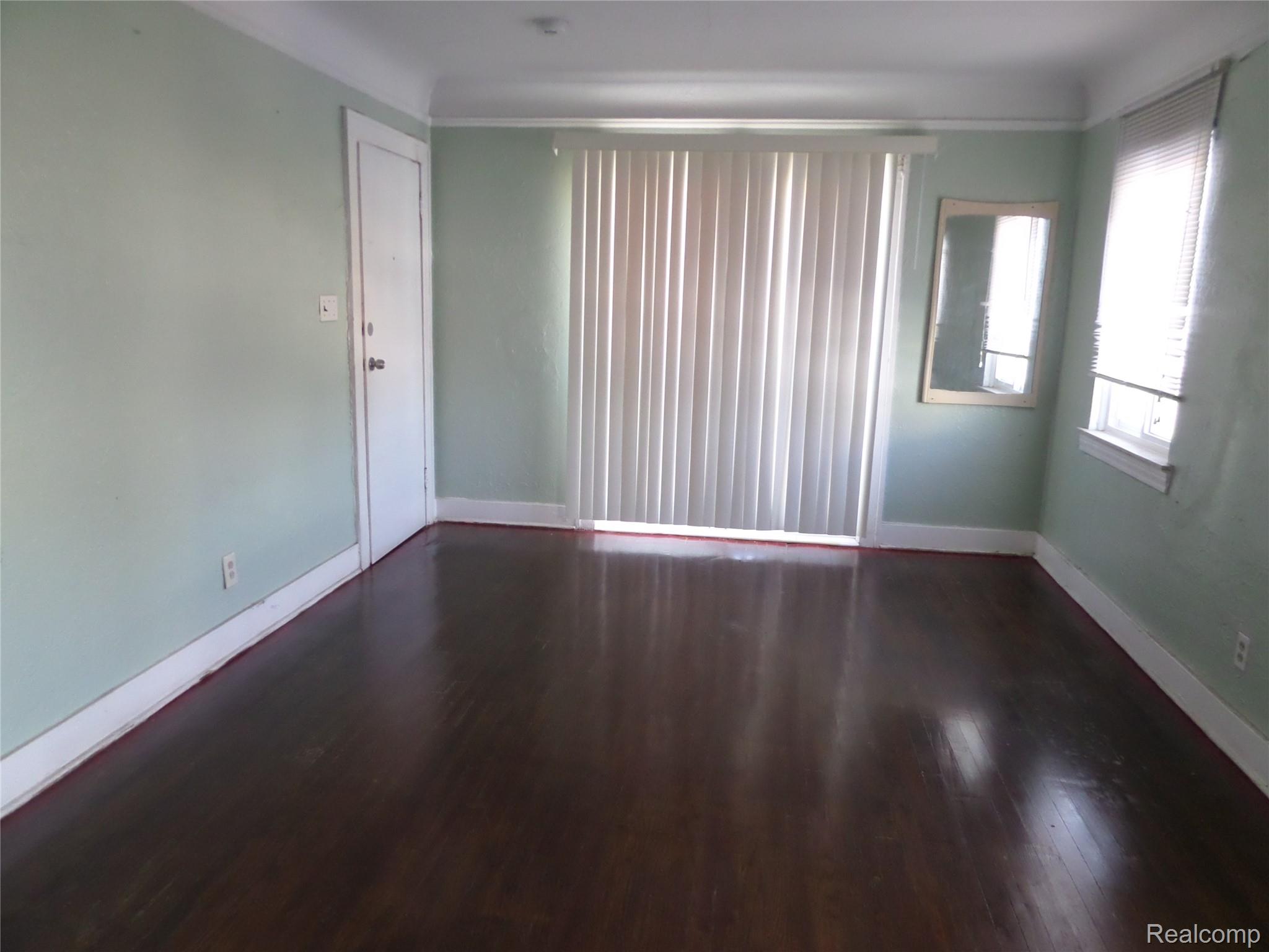 384 Perry Street Pontiac, MI 48342 - Photo 22 of 28 Unit 4 Empty room with dark wood finished floors and baseboards