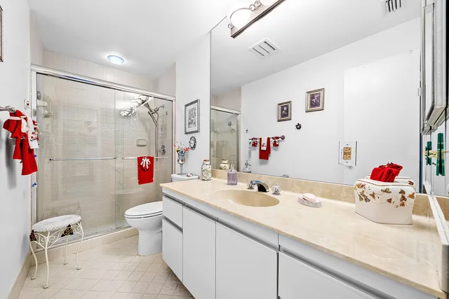 a living room with furniture a window and a potted plant