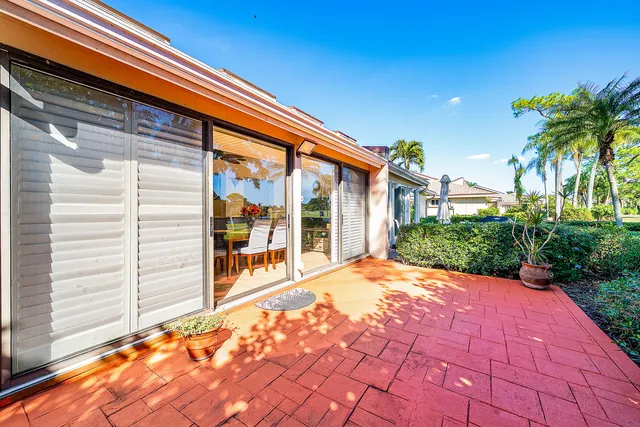 a backyard of a house with yard and outdoor seating