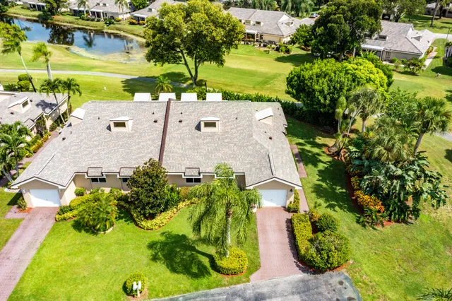 an aerial view of a house with a yard and garden