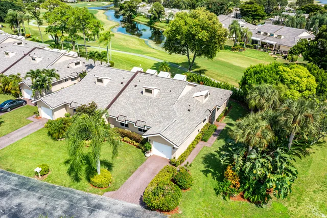 an aerial view of residential house with outdoor space and trees all around