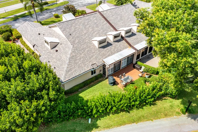 an aerial view of a house with yard swimming pool and outdoor seating
