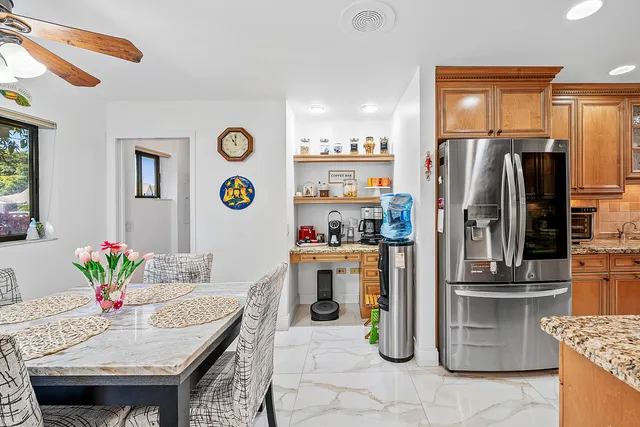 a kitchen with stainless steel appliances granite countertop a refrigerator and a stove