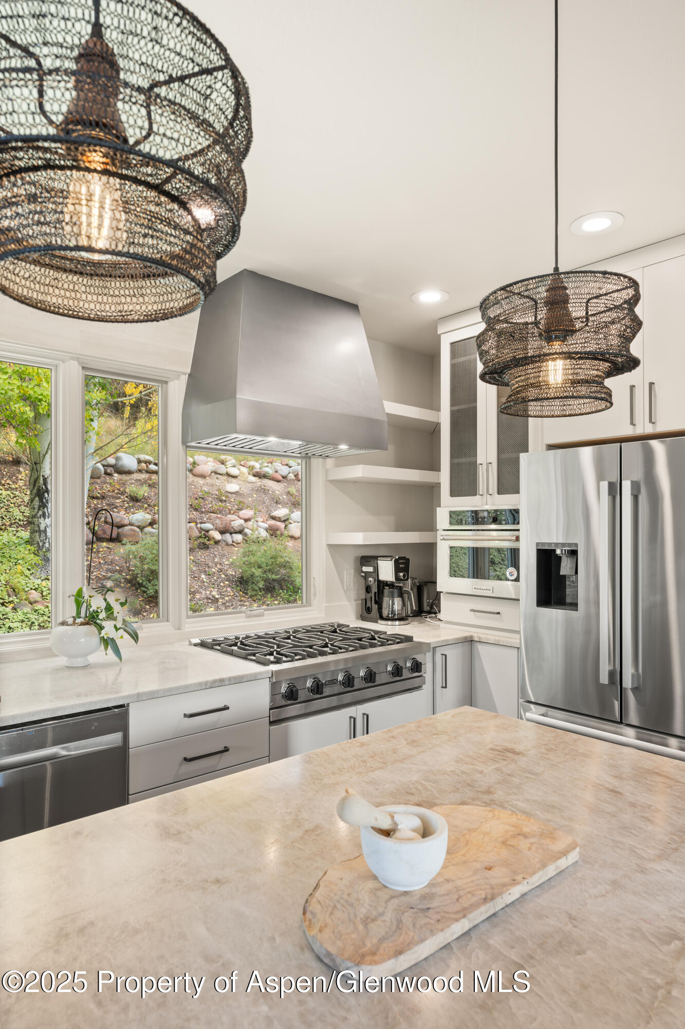 189 Light Hill Road Snowmass, CO 81654 - Photo 11 of 44 a kitchen with stainless steel appliances kitchen island granite countertop a stove a sink and a granite counter tops