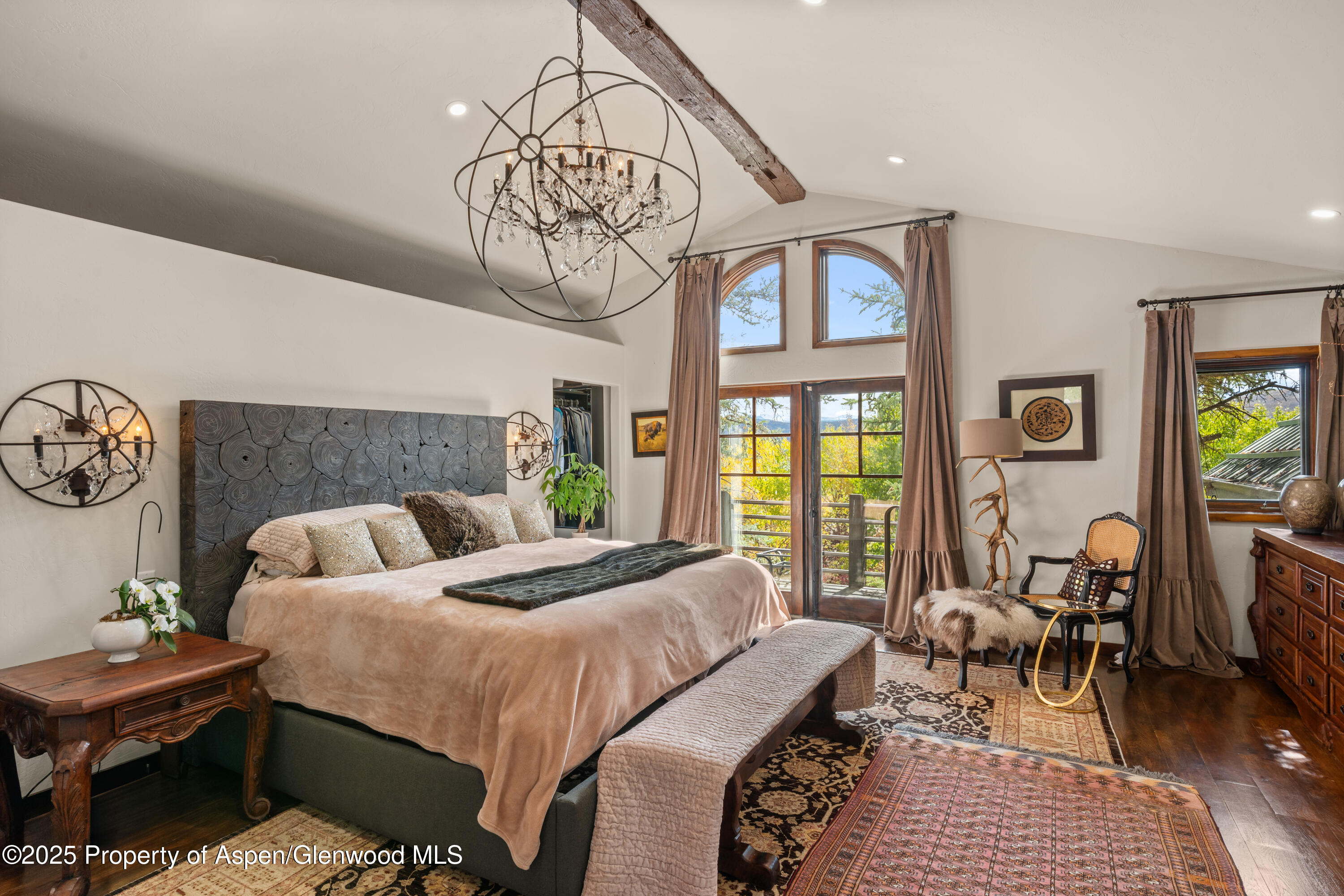 189 Light Hill Road Snowmass, CO 81654 - Photo 17 of 44 a bedroom with a bed and a table in it