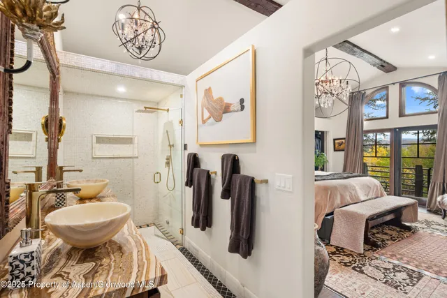 a bedroom with furniture and a chandelier