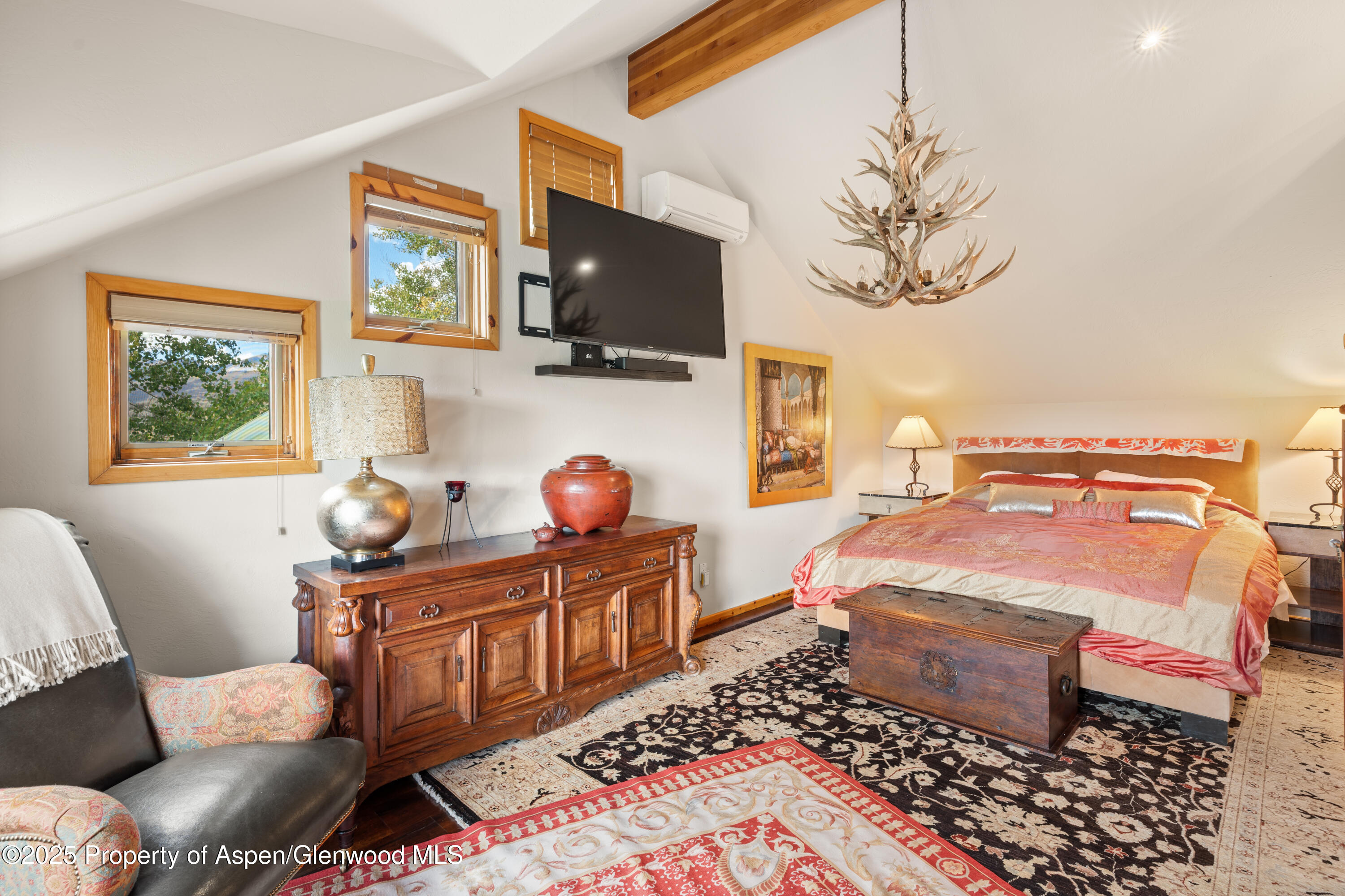 189 Light Hill Road Snowmass, CO 81654 - Photo 21 of 44 a bedroom with a bed and wooden floor