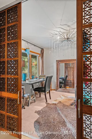 a dining room with furniture a rug and a large window