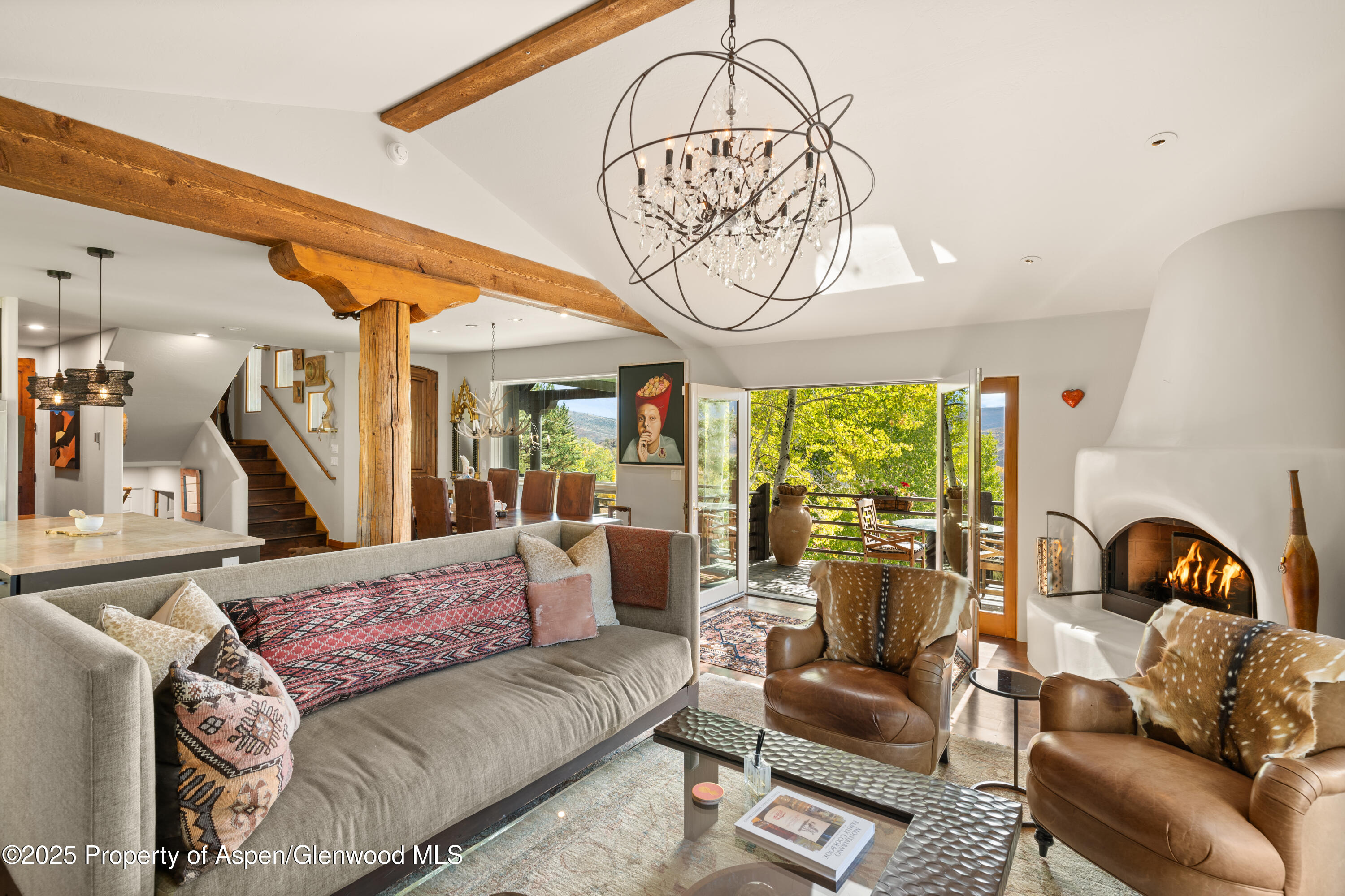 189 Light Hill Road Snowmass, CO 81654 - Photo 5 of 44 a living room with furniture a fireplace and a chandelier