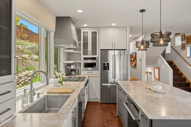 a kitchen with a sink stove and refrigerator