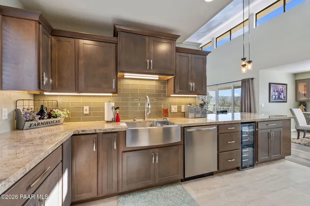 a very nice looking kitchen with granite countertop a large counter top appliances and cabinets
