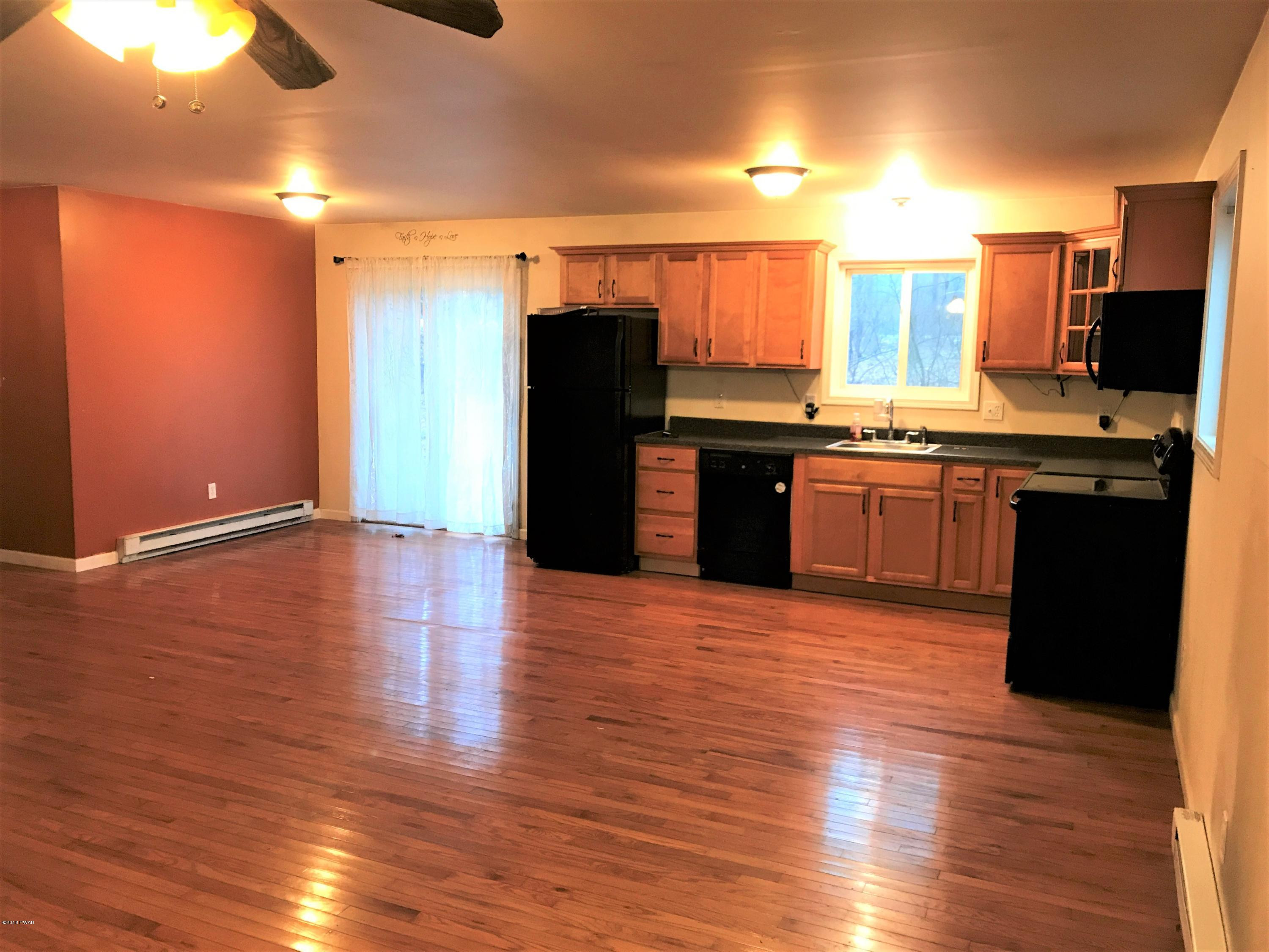 151 Raccoon Road Dingmans Ferry, PA 18328 - Photo 7 of 29 a large kitchen with stainless steel appliances granite countertop a refrigerator and a stove top oven