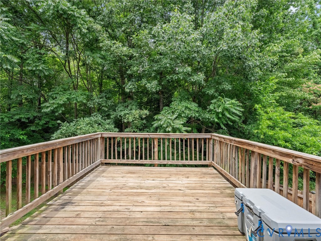 6712 Hedges Road Richmond, VA 23224 - Photo 32 of 34 Expansive wooden deck with a slatted railing, surr