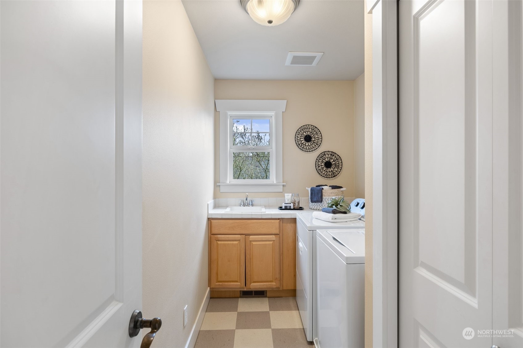 740 North 78th Street Seattle, WA 98103 - Photo 28 of 40 a room with a sink a washer and dryer