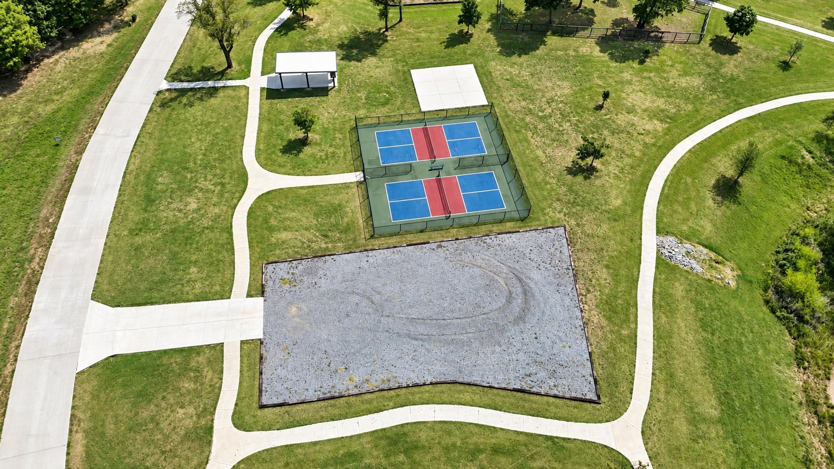 213 Patriot Pointe Road Eufaula, OK 74432 - Photo 17 of 18 Two pickleball courts, an open-air pavilion, playground, and extensive paved pathways set within a green space
