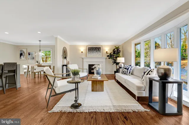 a dining hall with stainless steel appliances kitchen island granite countertop furniture and wooden floor