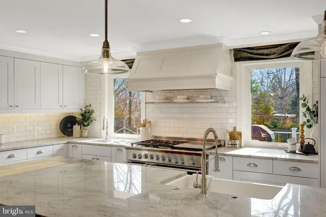 a bedroom with a bed lamps and dresser