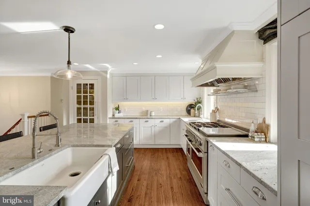 a view of a hallway with wooden floor and a cabinet