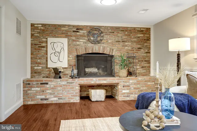 a living room with furniture and floor to ceiling windows