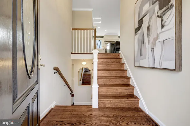 a living room with fireplace furniture and a wooden floor