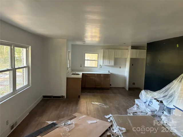 a view of a livingroom with furniture and staircase