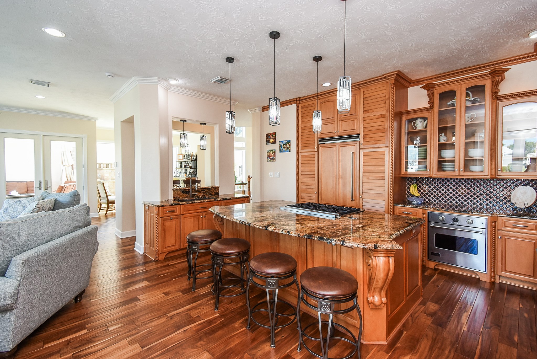 313 Harborside Circle Kemah, TX 77565 - Photo 14 of 35 a kitchen with stainless steel appliances granite countertop a stove a sink a refrigerator and chairs