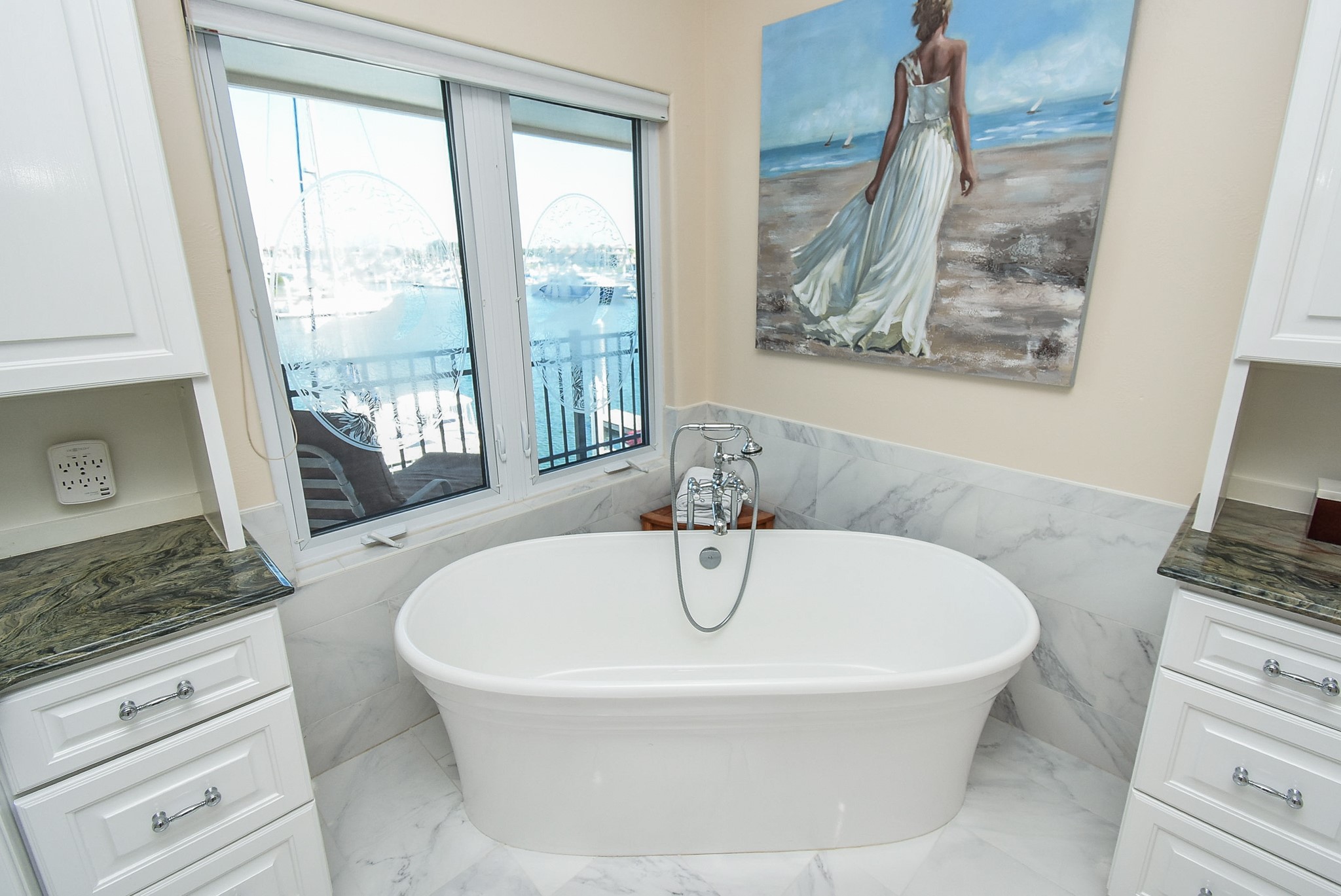 313 Harborside Circle Kemah, TX 77565 - Photo 23 of 35 a white bath tub sitting in a bathroom next to a window