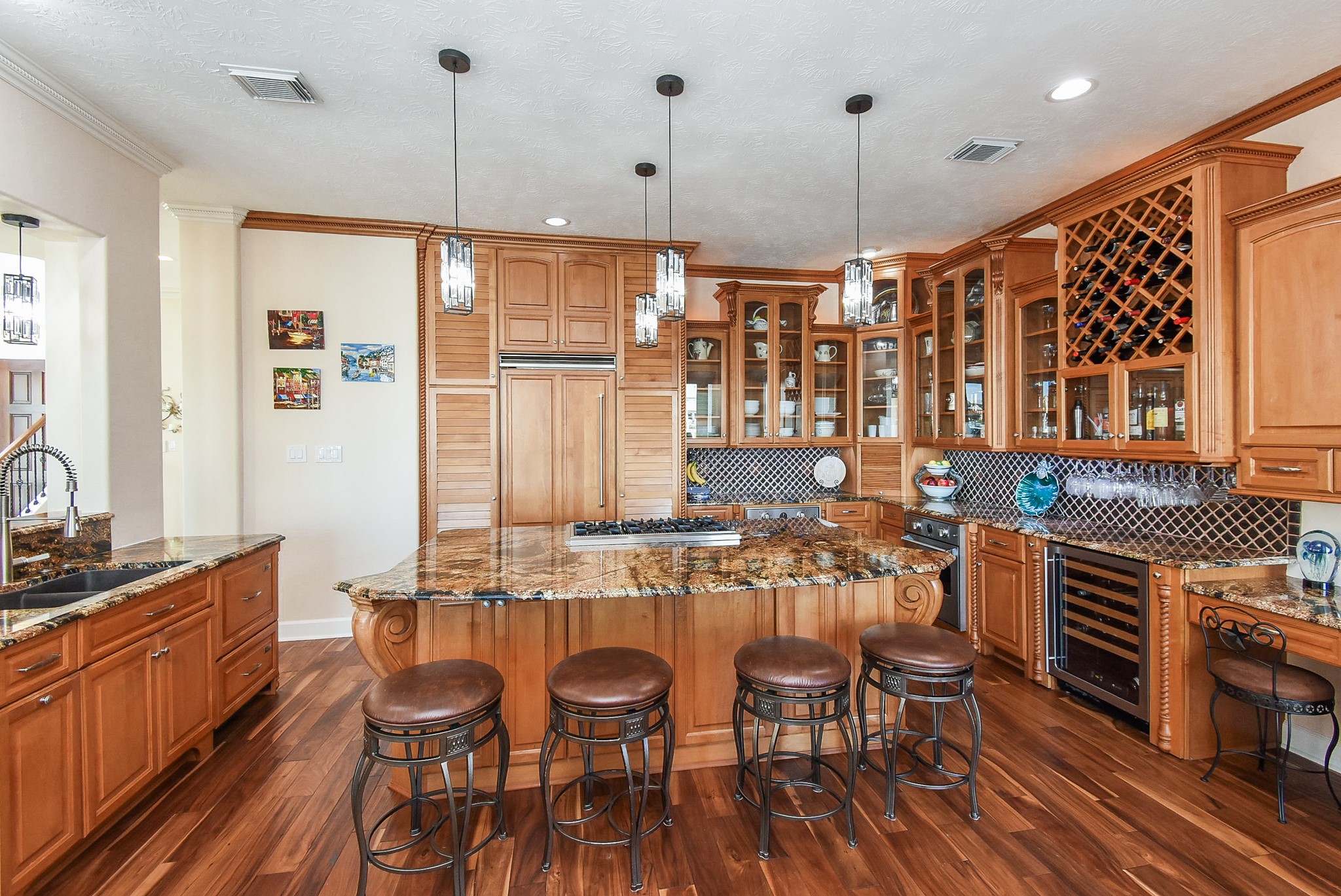 313 Harborside Circle Kemah, TX 77565 - Photo 9 of 35 a open kitchen with stainless steel appliances granite countertop a stove top oven a sink a dining table and chairs with wooden floor