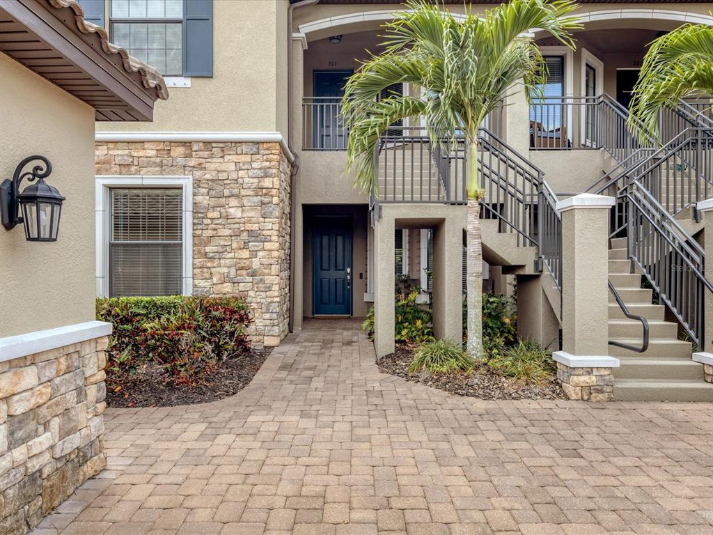 13604 Messina Loop, Unit 101 Lakewood Ranch, FL 34211 - Photo 1 of 1 a front view of a house with garden