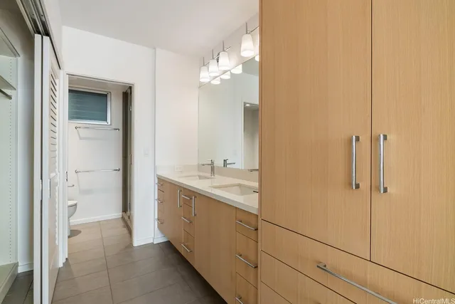 a bathroom with a double vanity sink and mirror