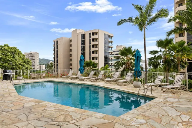 a swimming pool with outdoor seating and yard