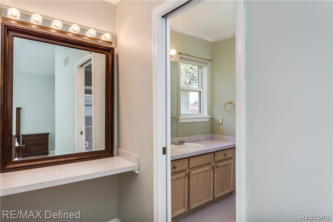 26 Eagle Ridge Road Lake Orion, MI 48360 - Photo 12 of 23 The master bathroom includes a wonderful view of the backyard, a vanity and a large shower stall.