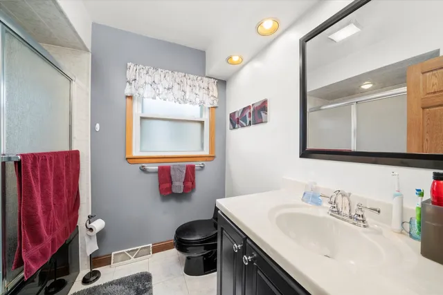 a bathroom with a sink vanity mirror and a toilet