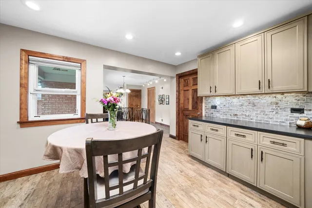 a kitchen with sink dining table and chairs