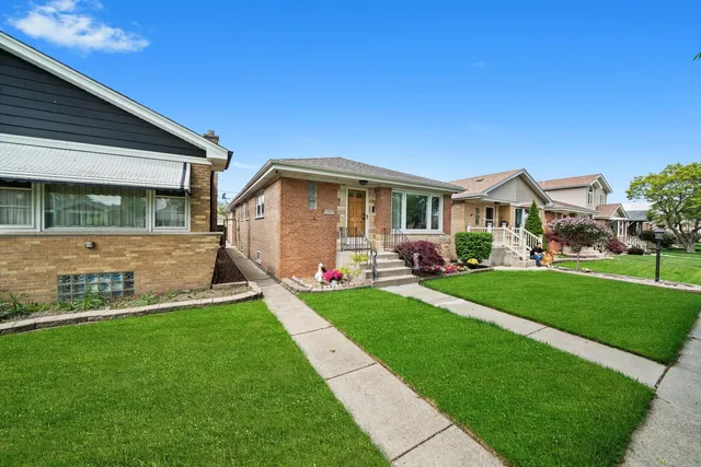 a front view of house with yard and green space