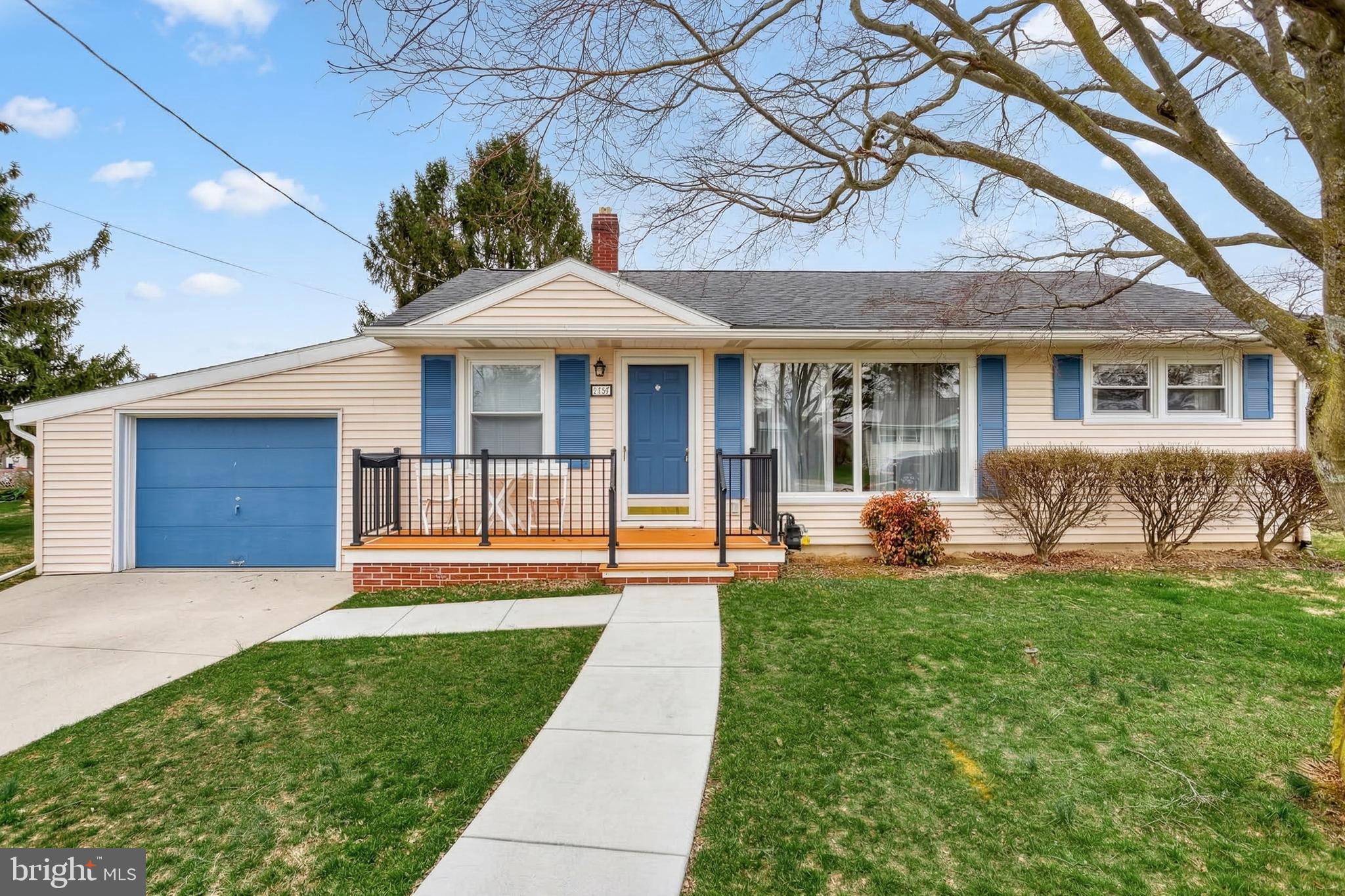 a front view of a house with a yard and porch