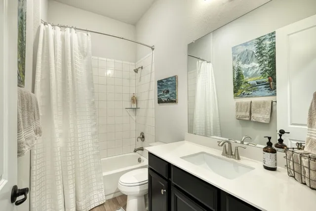 a bathroom with a sink toilet tub and shower