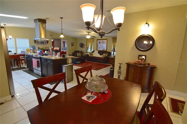a view of a dining room with furniture and chandelier