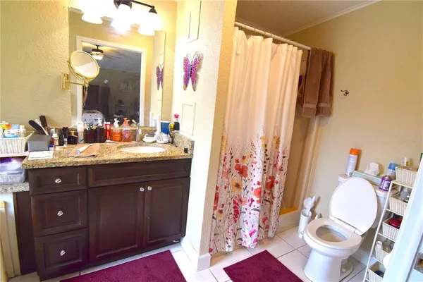 a bathroom with a sink vanity mirror and toilet