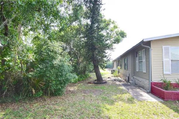 a view of a house with backyard and sitting area