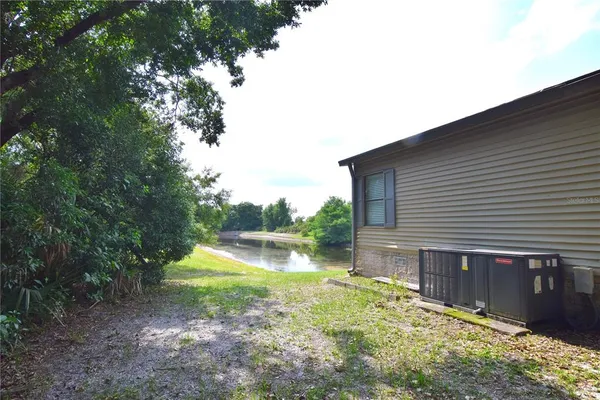 a backyard of a house with swimming pool and wooden fence
