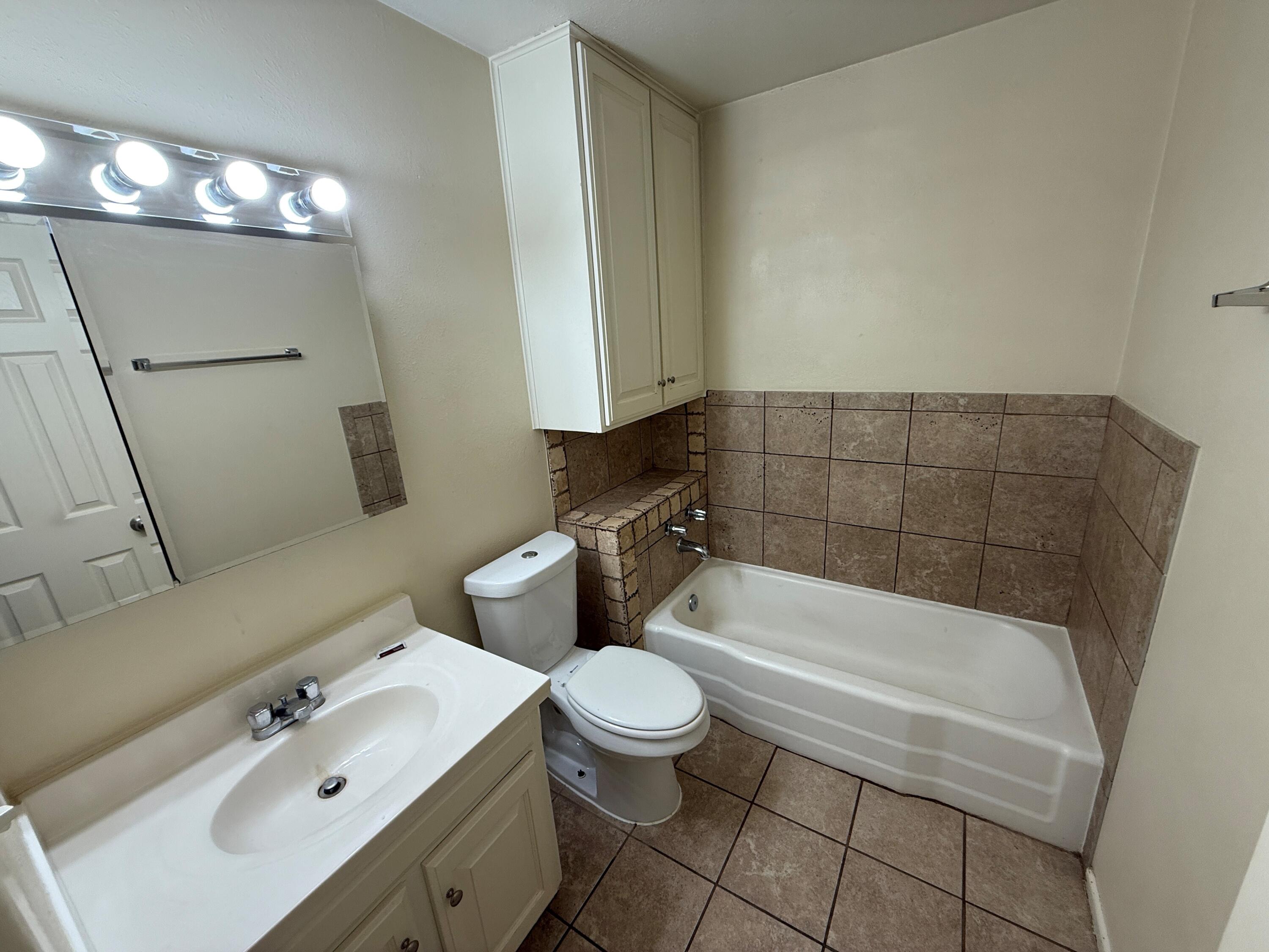 5420 42nd Street Lubbock, TX 79414 - Photo 5 of 8 a bathroom with a sink a toilet and shower