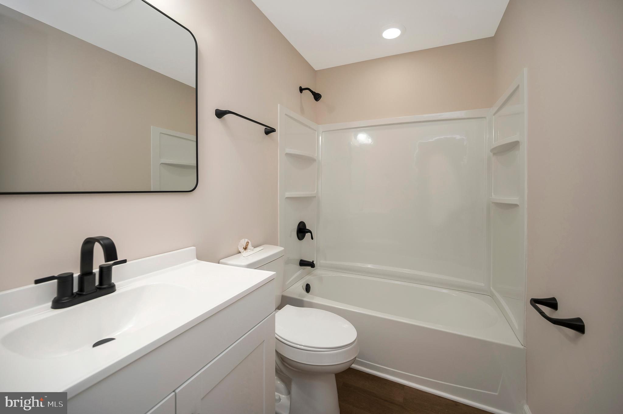 14169 Silver Hill Road Sumerduck, VA 22742 - Photo 26 of 40 a bathroom with a sink a toilet and a bathtub