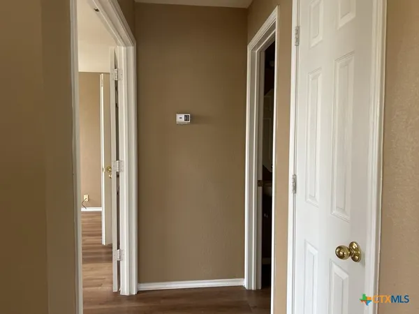 a view of a bathroom from a corridor