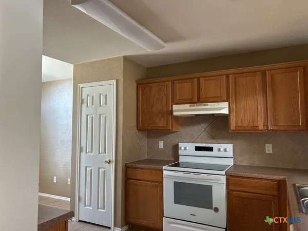 a kitchen with a stove and a cabinet