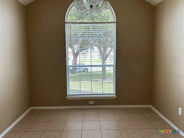 an empty room with a empty space and a window